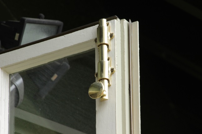 wooden window sash repair with brass detail